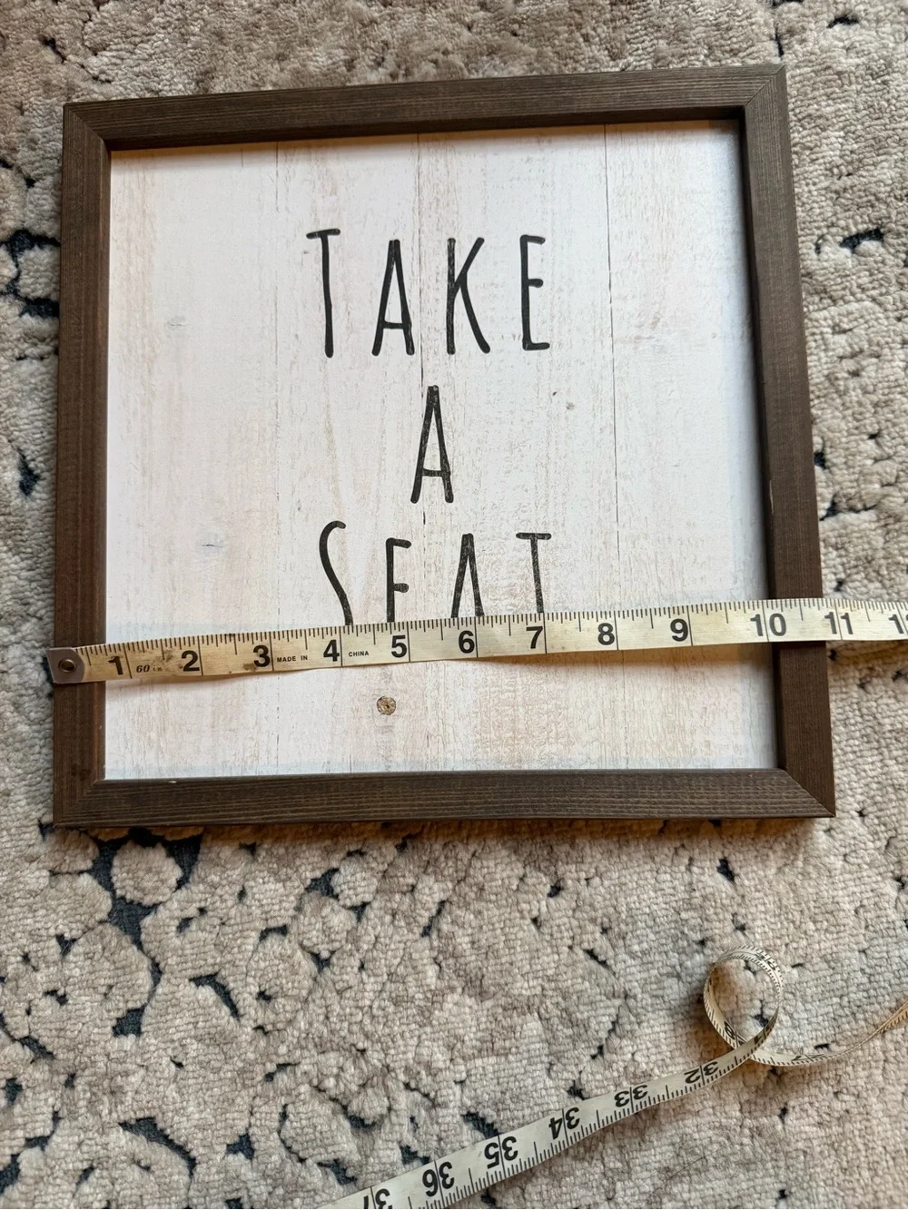 Take A Seat Framed Wall Sign - Brown Frame, White Face
